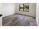 Bright bedroom with wood-look floors and a window offering an outdoor view at 346 Emerald Rd, Ocala, FL 34472