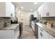 Modern kitchen featuring stainless steel appliances, granite countertops, and white cabinetry at 346 Emerald Rd, Ocala, FL 34472