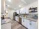 Modern kitchen featuring stainless steel appliances, granite countertops, and white cabinetry at 346 Emerald Rd, Ocala, FL 34472