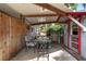 Cozy outdoor space with table and chairs, perfect for relaxing and enjoying the lush backyard surroundings at 3823 Se 49Th St, Ocala, FL 34480