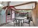 Relaxing covered outdoor space features a table and chairs, perfect for al fresco dining and enjoying the backyard at 3823 Se 49Th St, Ocala, FL 34480