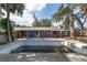 Backyard showcasing the swimming pool and patio area with mature trees at 3823 Se 49Th St, Ocala, FL 34480