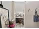 Cozy bathroom with makeup vanity, mirror and stool, plus unique tiled flooring at 3823 Se 49Th St, Ocala, FL 34480