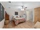 Cozy bedroom with wood flooring, a ceiling fan, and a comfortable bed with neutral decor at 3823 Se 49Th St, Ocala, FL 34480