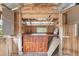 Cabana interior featuring a bar with wood cabinets, drawers and shelves, sink, and natural light streaming through a window at 3823 Se 49Th St, Ocala, FL 34480