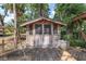 Charming wooden cabana with screened windows and a rustic, comfortable outdoor feel on a sunny day at 3823 Se 49Th St, Ocala, FL 34480