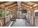 Well-lit cabana interior featuring wood construction, ample seating, and a mounted television for entertainment at 3823 Se 49Th St, Ocala, FL 34480