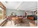 Open-concept dining room with wood-look flooring and an elegant chandelier at 3823 Se 49Th St, Ocala, FL 34480