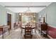 Bright dining room featuring a vintage chandelier, large windows, and classic furnishings at 3823 Se 49Th St, Ocala, FL 34480