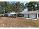 Charming single-story home with a well-maintained lawn and a two-car garage, showcasing curb appeal at 3823 Se 49Th St, Ocala, FL 34480