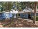 The home's exterior features a combination of white siding and blue brick, and mature trees in the front yard at 3823 Se 49Th St, Ocala, FL 34480