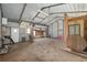 Open metal garage space with doorway to fenced in yard, seating and open space at 3823 Se 49Th St, Ocala, FL 34480