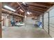 A garage interior view showcases open space with exposed wood rafters and cinder block walls, offering ample parking at 3823 Se 49Th St, Ocala, FL 34480