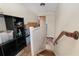 Upstairs hallway with wood railing, natural light, and storage area at 3823 Se 49Th St, Ocala, FL 34480