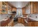 Galley kitchen featuring custom wood cabinetry, stainless steel appliances, and tiled backsplash at 3823 Se 49Th St, Ocala, FL 34480