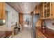 Rustic kitchen featuring custom wood cabinetry, stainless steel appliances, and wood panel ceiling at 3823 Se 49Th St, Ocala, FL 34480