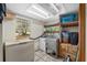 Spacious laundry room with washer, dryer, freezer, window, and storage shelves at 3823 Se 49Th St, Ocala, FL 34480