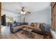 Spacious living room featuring beamed ceiling, ceiling fan, and comfortable sectional couch at 3823 Se 49Th St, Ocala, FL 34480
