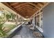 Inviting covered porch with comfortable seating, offering a relaxing outdoor space with a view of the lush surroundings at 3823 Se 49Th St, Ocala, FL 34480