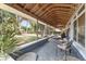 Inviting covered porch with seating, perfect for relaxing and enjoying views of the spacious backyard at 3823 Se 49Th St, Ocala, FL 34480