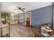Inviting screened porch with comfortable wicker furniture and wood-look flooring at 3823 Se 49Th St, Ocala, FL 34480