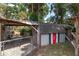 View of shed from yard with covered patio and fence, offering additional storage, backyard recreation, and privacy at 3823 Se 49Th St, Ocala, FL 34480