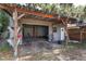 Outdoor shed for storage featuring a roll-up garage door and a workshop, perfect for hobbies and outdoor equipment at 3823 Se 49Th St, Ocala, FL 34480