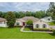 Aerial view of a home showcasing a well-manicured front yard with a vibrant red front door at 4015 Se 22Nd St, Ocala, FL 34471