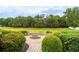 Backyard firepit area with landscaping and serene views at 4015 Se 22Nd St, Ocala, FL 34471