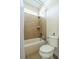 Bathroom with shower-tub combo, tiled walls and toilet at 4015 Se 22Nd St, Ocala, FL 34471