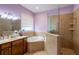 The bathroom has a tiled walk-in shower, soaking tub, and window at 4015 Se 22Nd St, Ocala, FL 34471