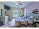 Bright bedroom features a ceiling fan, TV, and natural light from the windows at 4015 Se 22Nd St, Ocala, FL 34471