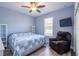 Bright bedroom features a ceiling fan, TV, and natural light from the window at 4015 Se 22Nd St, Ocala, FL 34471