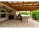 Entertainer's covered patio with outdoor kitchen, grill, mini-fridge, and TV hookups at 4015 Se 22Nd St, Ocala, FL 34471