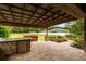 Spacious covered patio featuring a full outdoor kitchen, hot tub, and landscaped backyard views at 4015 Se 22Nd St, Ocala, FL 34471