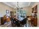 Charming dining room featuring a tray ceiling and a stylish chandelier at 4015 Se 22Nd St, Ocala, FL 34471