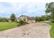 Paver driveway leading to a well-maintained home with lush landscaping and mature trees at 4015 Se 22Nd St, Ocala, FL 34471
