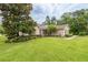 Beautifully landscaped front yard highlighting a charming single-story home with a red door at 4015 Se 22Nd St, Ocala, FL 34471