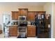 Well-equipped kitchen featuring stainless steel appliances and warm wood cabinetry at 4015 Se 22Nd St, Ocala, FL 34471