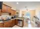 Warm kitchen with granite countertops, stainless steel appliances, and adjacent eat-in area at 4015 Se 22Nd St, Ocala, FL 34471