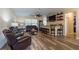 Spacious living room with wood flooring, a ceiling fan and custom bar at 4015 Se 22Nd St, Ocala, FL 34471