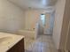 Bathroom featuring a tub, single sink vanity, and tiled flooring at 4460 Sw 44Th St, Ocala, FL 34474
