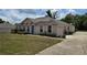 A view of a single story home showing the garage, landscaping, and driveway with a blue entry door at 4460 Sw 44Th St, Ocala, FL 34474