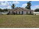 Charming single-story home with a well-manicured lawn, lush landscaping, and a welcoming front entrance at 4460 Sw 44Th St, Ocala, FL 34474