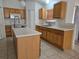 Large kitchen featuring a kitchen island with double sinks and lots of countertop and cabinet space at 4460 Sw 44Th St, Ocala, FL 34474