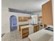 Open kitchen featuring wood cabinets, a sink, dishwasher and tile flooring at 4460 Sw 44Th St, Ocala, FL 34474