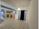 Open-concept living area with a kitchen island, tile flooring, and natural light at 4460 Sw 44Th St, Ocala, FL 34474