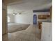 Open concept living room with carpet, tiled floor entryway and view of the kitchen at 4460 Sw 44Th St, Ocala, FL 34474