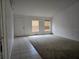 Inviting living room featuring neutral carpet, light walls, and bright windows at 4460 Sw 44Th St, Ocala, FL 34474