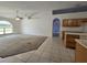 Bright living room with ceiling fan, and a partial view of the kitchen at 4460 Sw 44Th St, Ocala, FL 34474